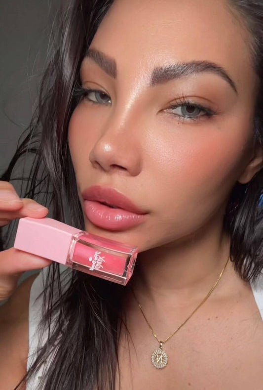 Model showcasing Strawberry Kiss-Lip Oil, a hydrating lip oil for soft lips.