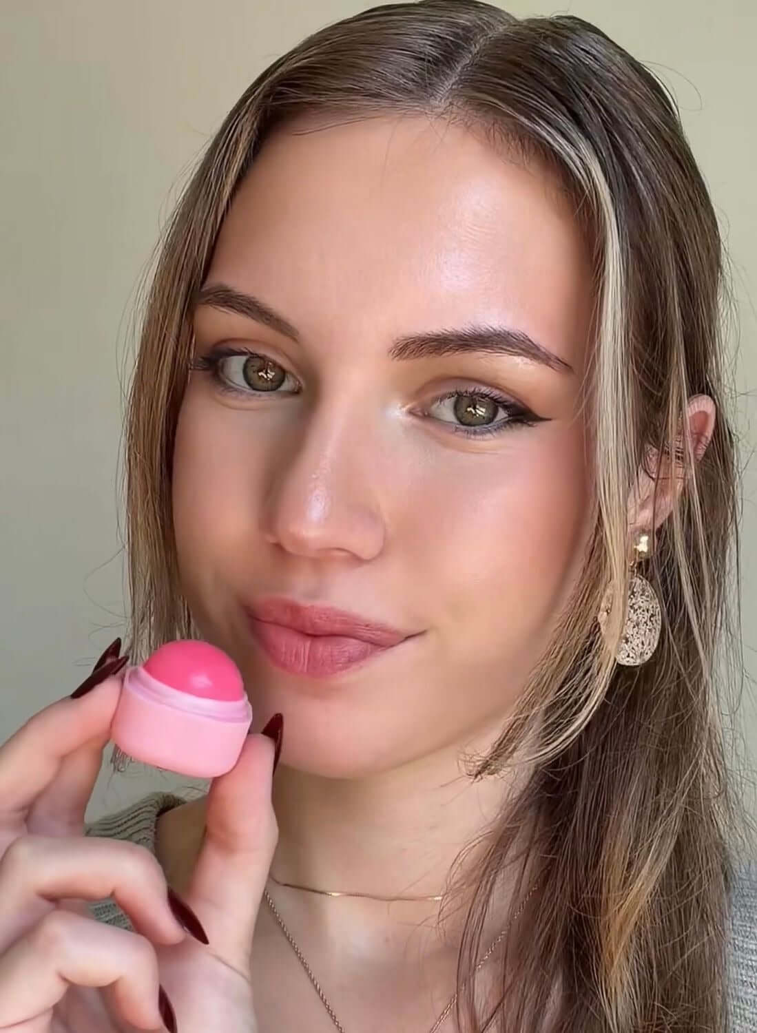 Strawberry Bomb S-Bomb Elevate Bundle skincare model holding pink product